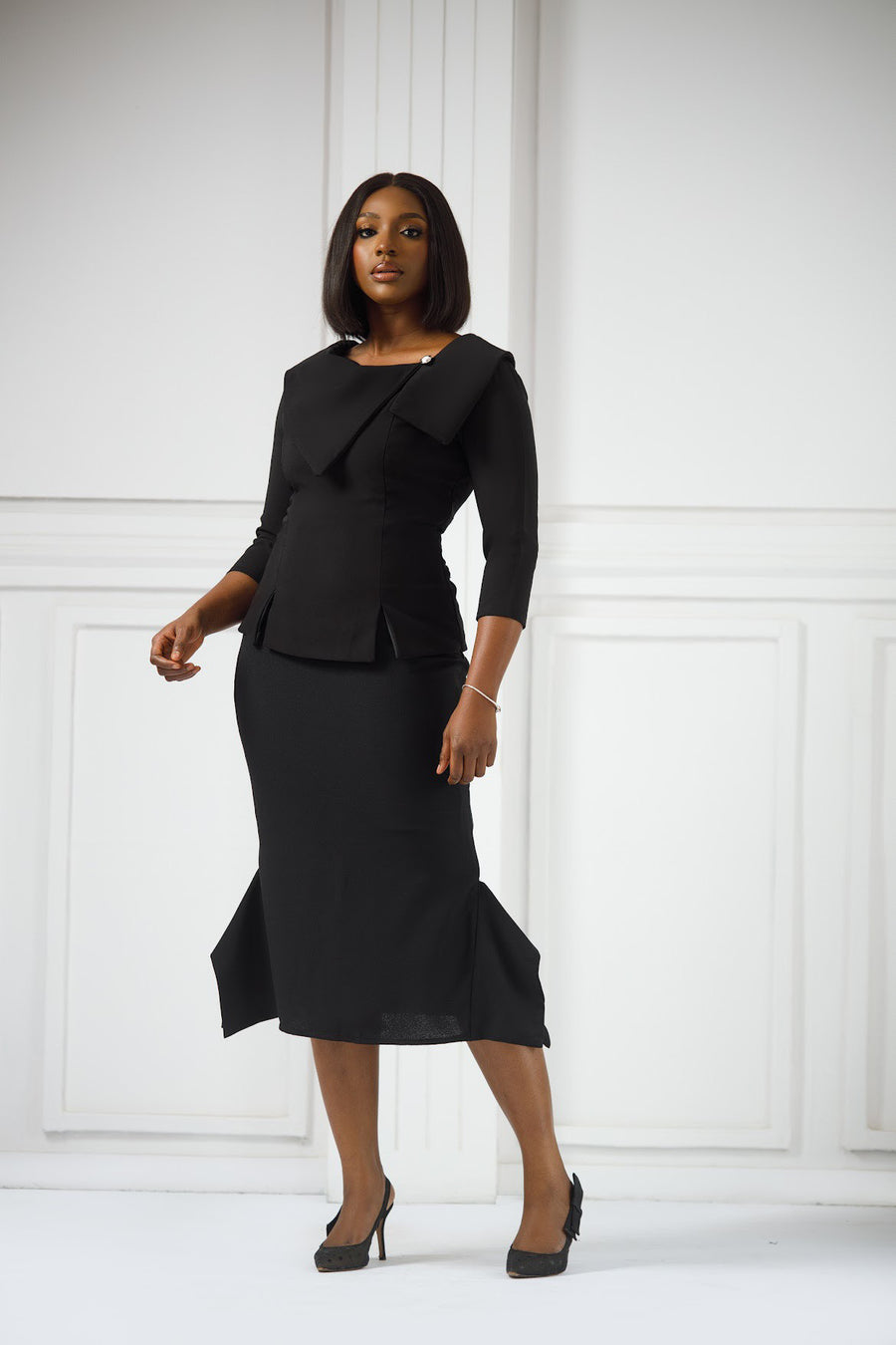 Erilyn Nkiru set with a fitted top and midi-length skirts